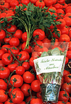 Tomatoes and herbs, outdoor market. Munich, Germany.